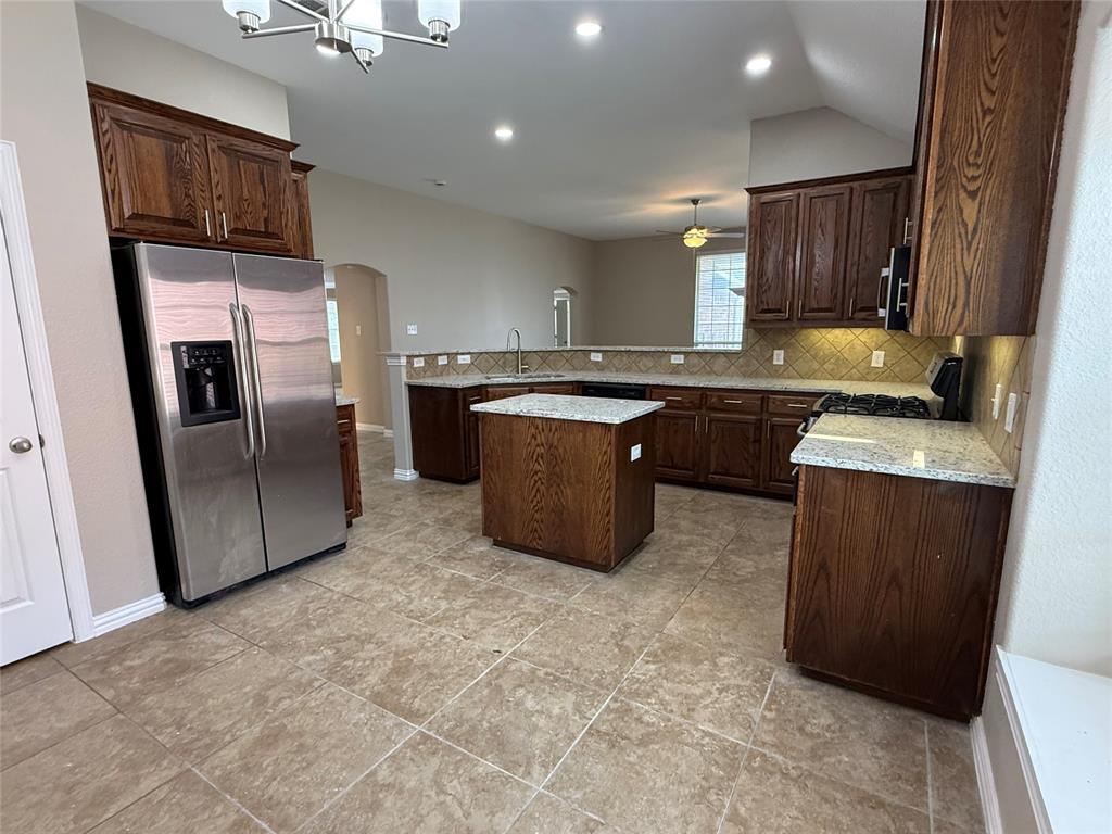 108 Cole Street Forney, TX 75126 - Photo 14 of 39 a kitchen with stainless steel appliances granite countertop a stove a sink a refrigerator and a microwave