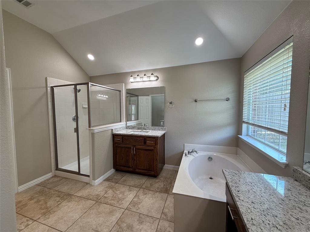 108 Cole Street Forney, TX 75126 - Photo 25 of 39 a bathroom with a granite countertop sink mirror and bathtub