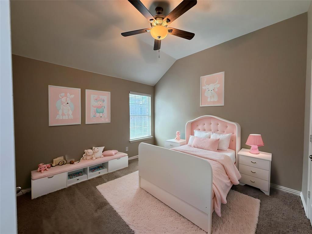 108 Cole Street Forney, TX 75126 - Photo 28 of 39 a bedroom with bed and a chandelier