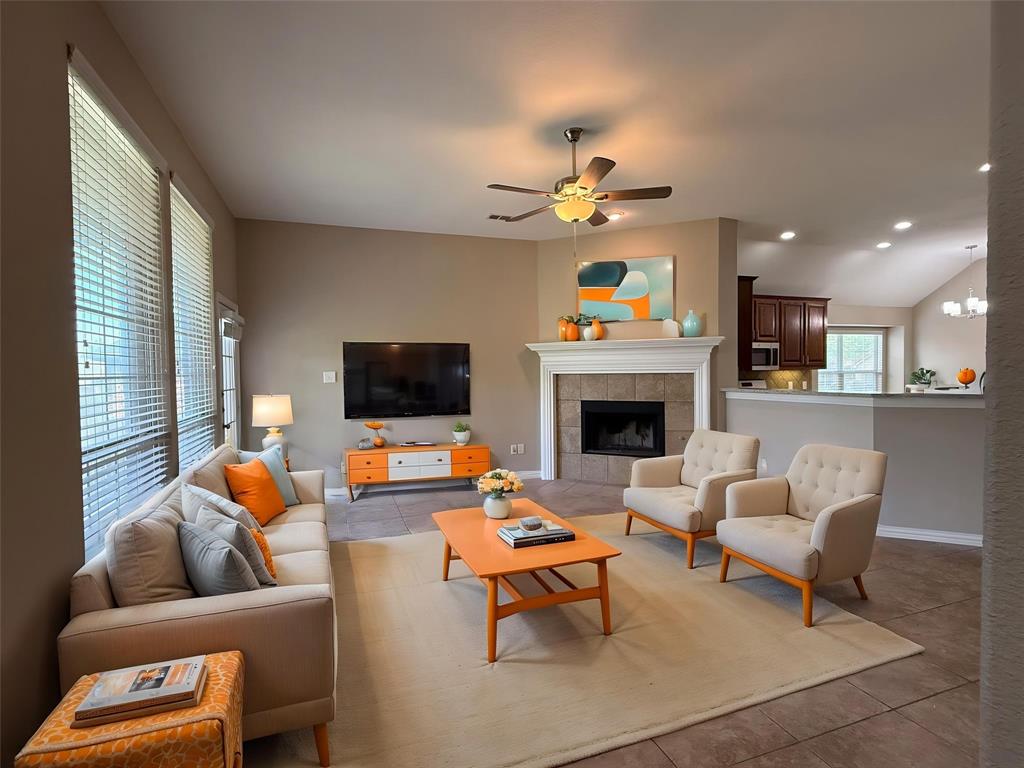 108 Cole Street Forney, TX 75126 - Photo 5 of 39 a living room with furniture a flat screen tv and a fireplace