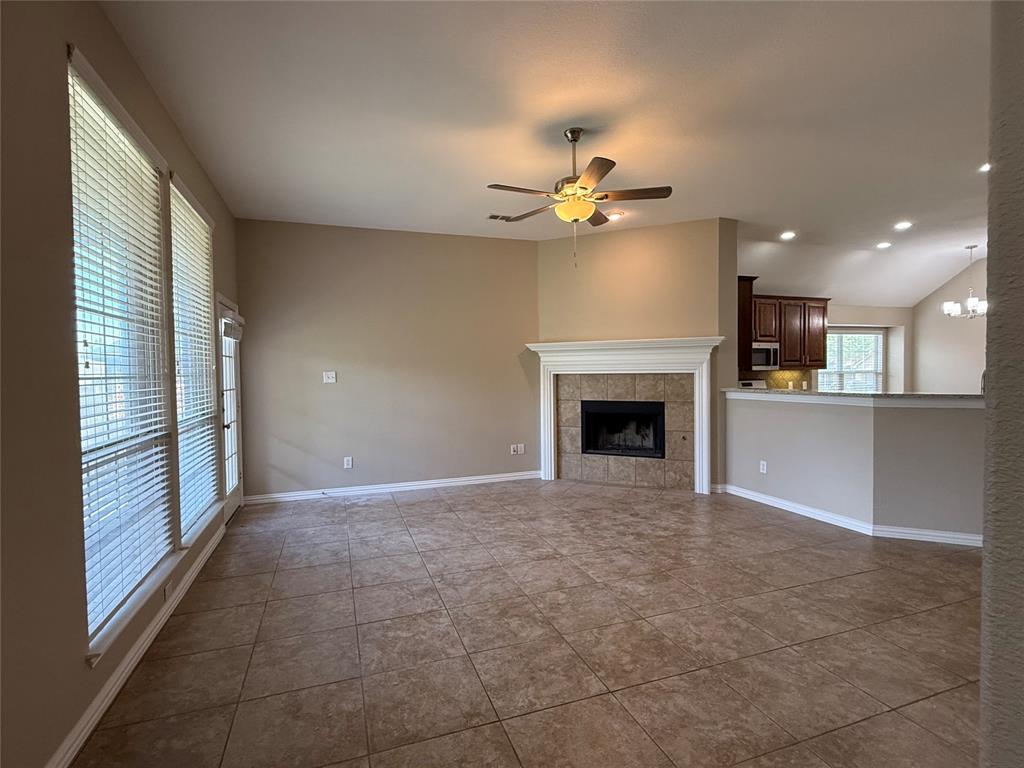 108 Cole Street Forney, TX 75126 - Photo 6 of 39 a view of an empty room with a fireplace and a window