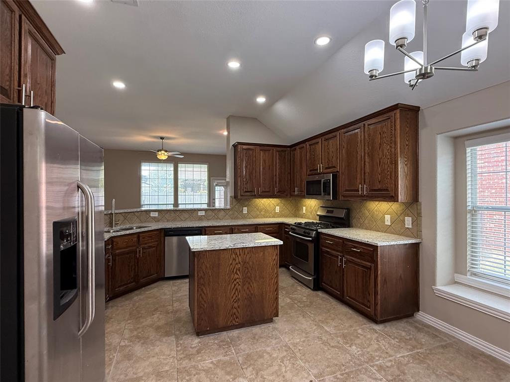 108 Cole Street Forney, TX 75126 - Photo 10 of 39 a kitchen with stainless steel appliances granite countertop a stove and a sink