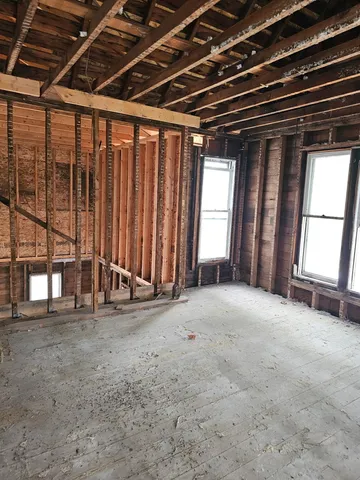 a view of an empty room with a fireplace