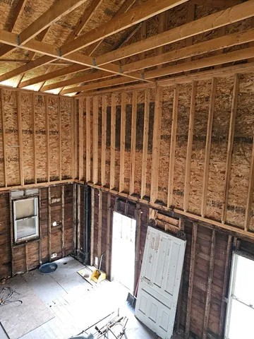 a view of an empty room with wooden walls