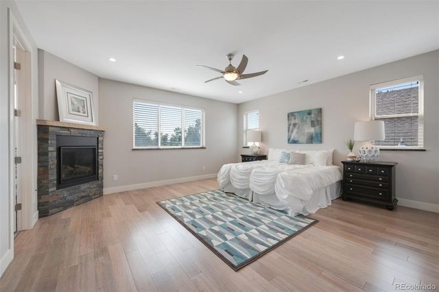 a bedroom with a large bed and a fireplace