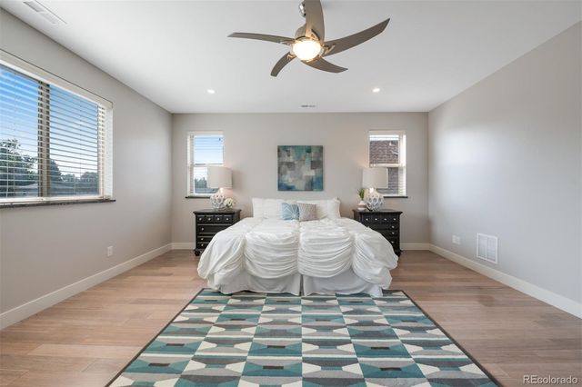 a spacious bedroom with a bed and a window