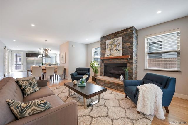 a living room with furniture a fireplace and a table