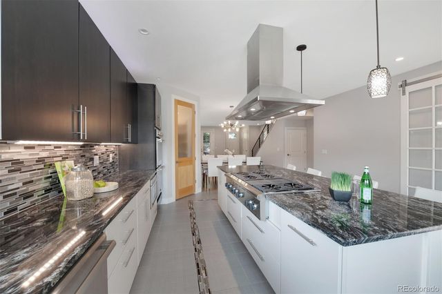 a kitchen with stove and refrigerator