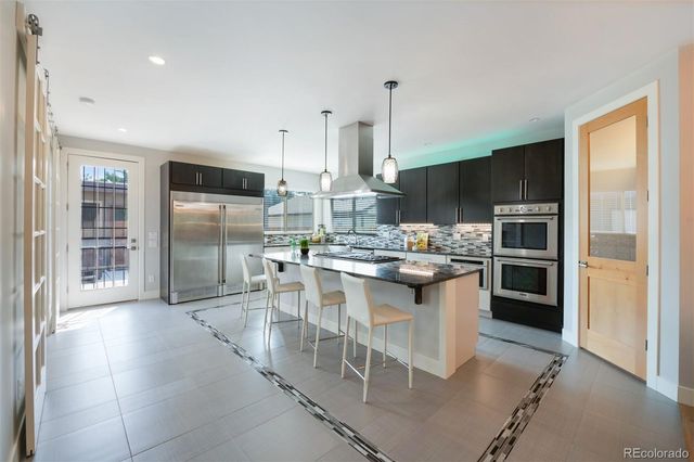 a kitchen with kitchen island a sink appliances and cabinets