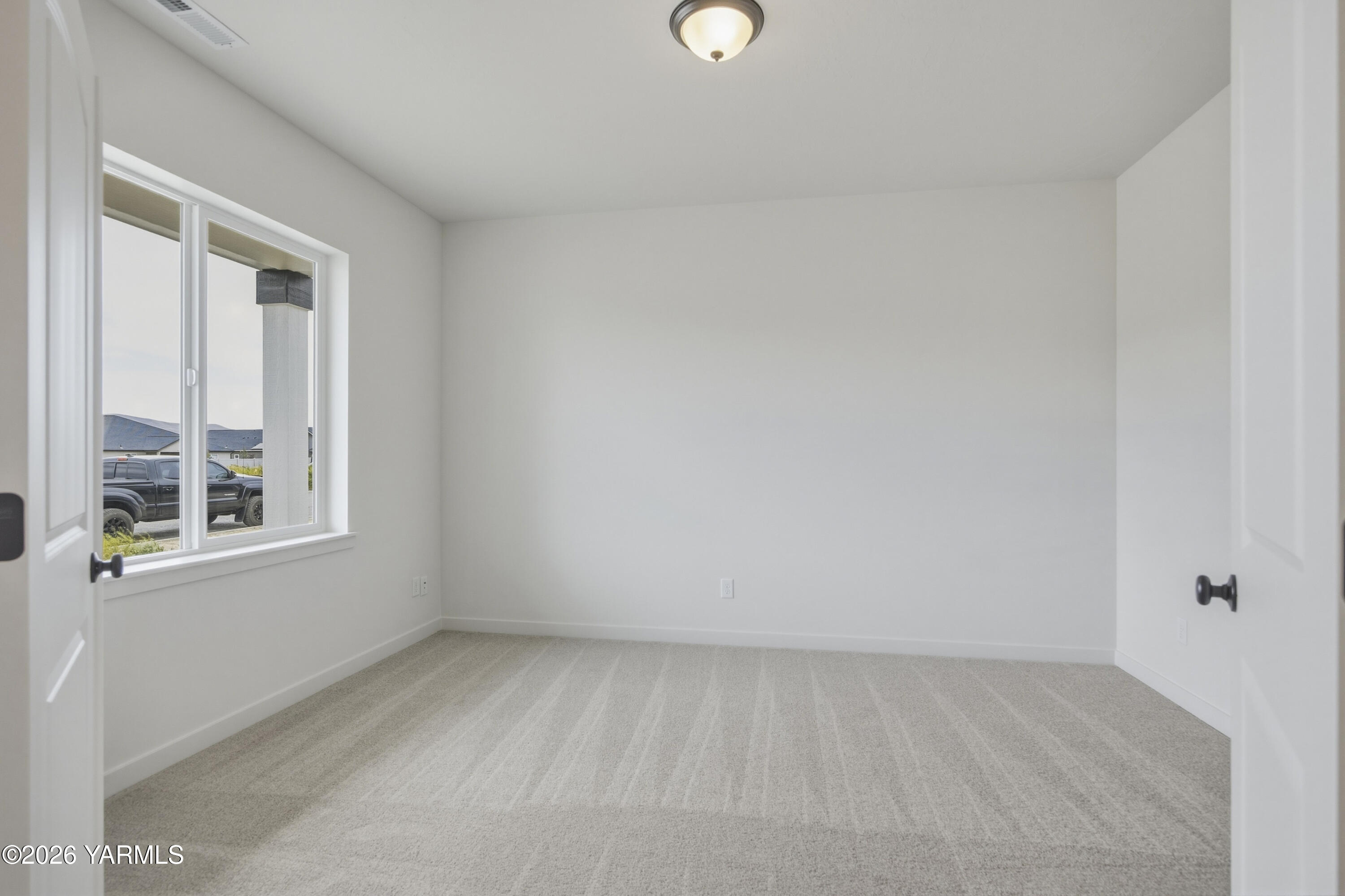 215 Packer Street Prosser, WA 99350 - Photo 4 of 45 a view of an empty room with a window