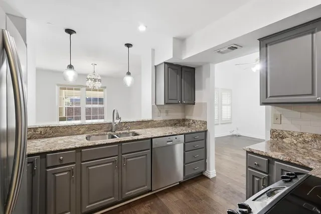 a kitchen with a sink stove and wooden cabinets