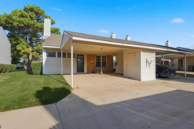 a front view of a house with a garden and yard