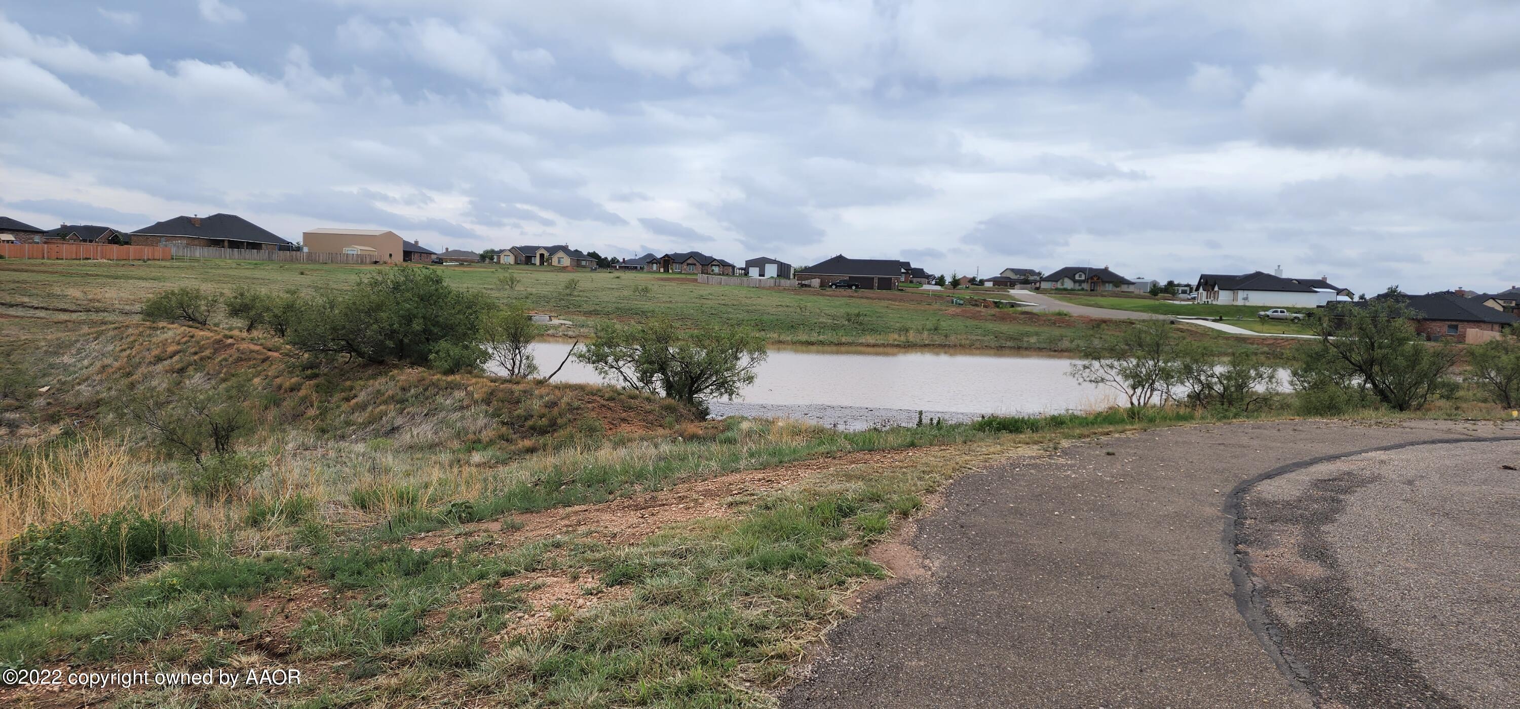 19600 Rock Pass Amarillo, TX 79124 - Photo 3 of 5 a view of a lake with houses in the back