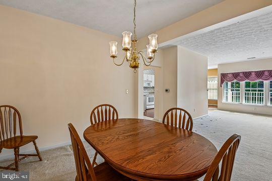 9511 Kingscroft Terrace, Unit 9511F Perry Hall, MD 21128 - Photo 12 of 38 a view of a dining room with furniture and window