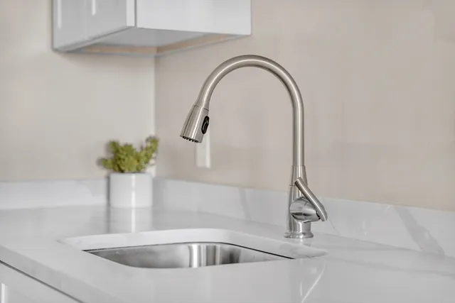 a bedroom with a bed and a lamp