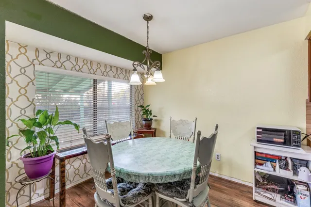 a view of a dining room with furniture and wooden floor