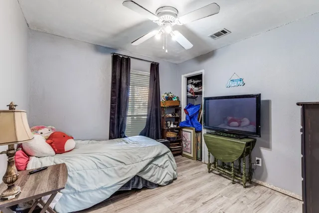 a bedroom with a bed and a chandelier