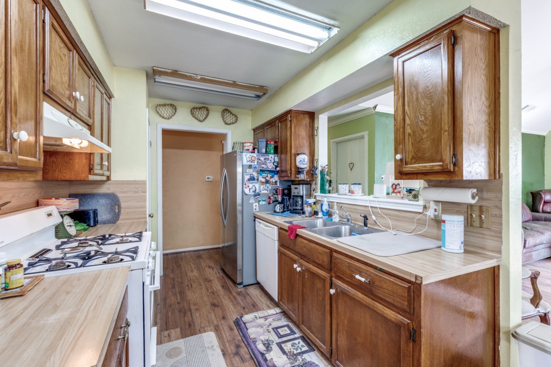 1301 Wayne Drive Round Rock, TX 78664 - Photo 5 of 21 a kitchen with stainless steel appliances granite countertop a sink stove and refrigerator
