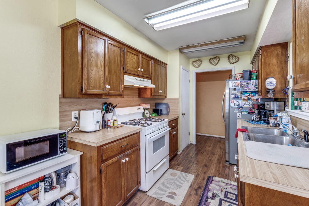 1301 Wayne Drive Round Rock, TX 78664 - Photo 7 of 21 a kitchen with stainless steel appliances granite countertop a sink stove and cabinets