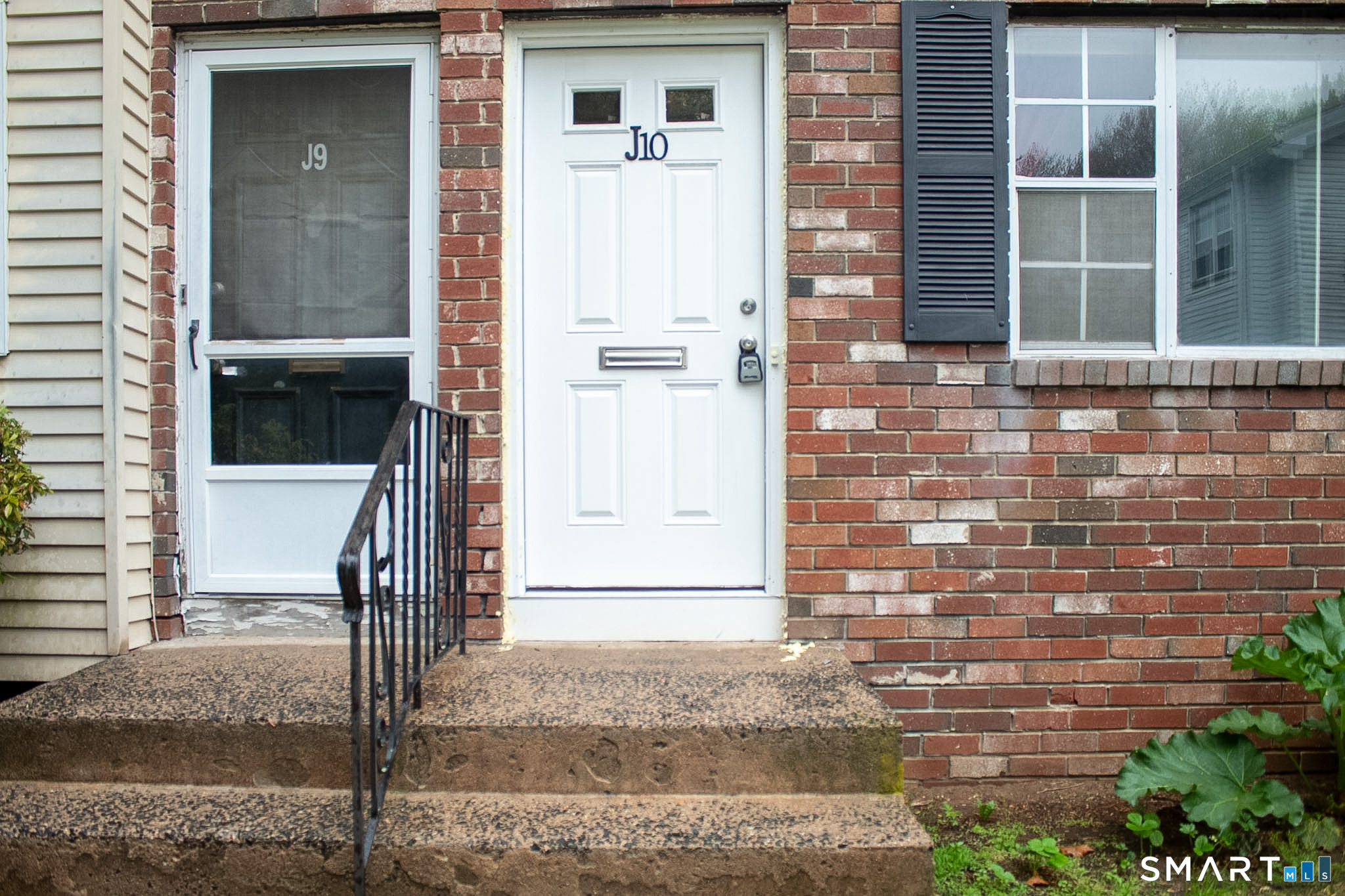 10 Georgetown Drive, Unit J Enfield, CT 06082 - Photo 1 of 15 a front view of a building with a glass door