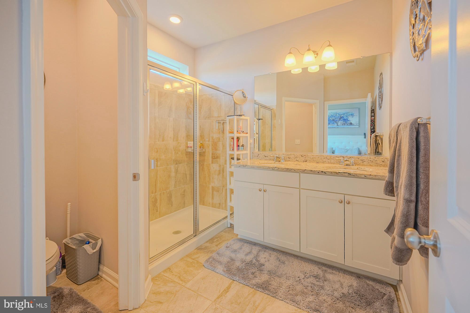 15 Turin Way Mount Laurel, NJ 08054 - Photo 21 of 36 a bathroom with a granite countertop sink a mirror and a shower