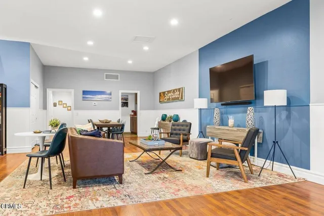 a dining room with furniture and wooden floor
