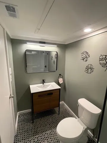 a bathroom with a toilet a shower and a window