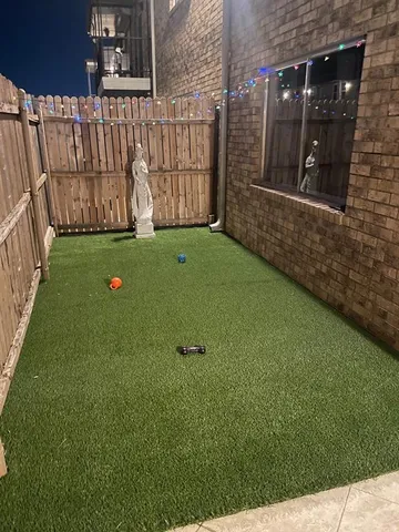 a backyard of a house with a yard and outdoor seating