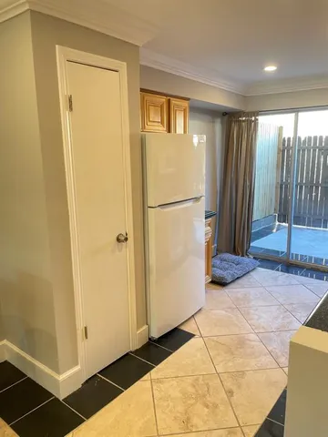 a view of a hallway with a refrigerator