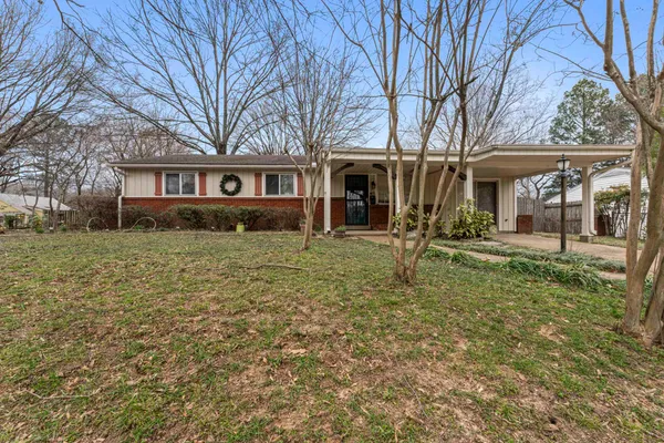 a house that has a tree in front of it