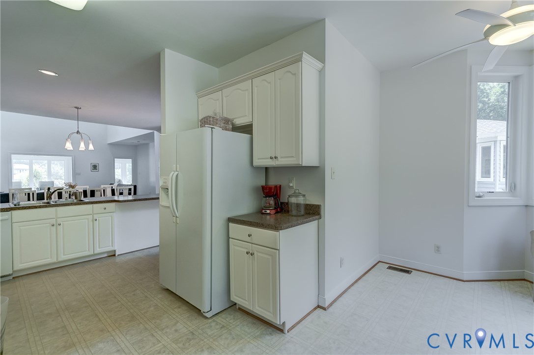 7902 Johnson Road Petersburg, VA 23805 - Photo 19 of 55 Kitchen featuring white cabinetry, light-toned flo