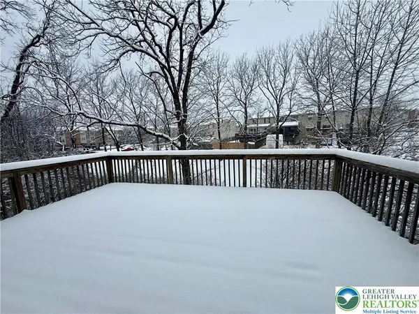 a view of balcony with wooden fence