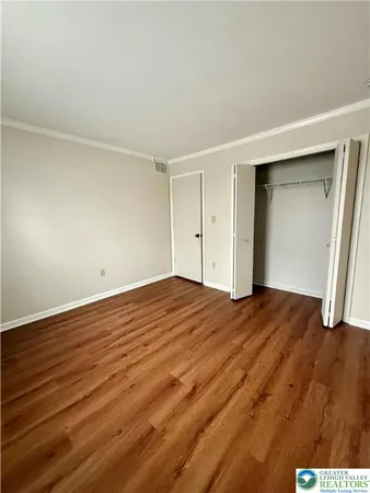 a view of empty room with wooden floor
