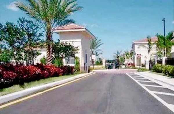 a front view of a house with a garden and plants