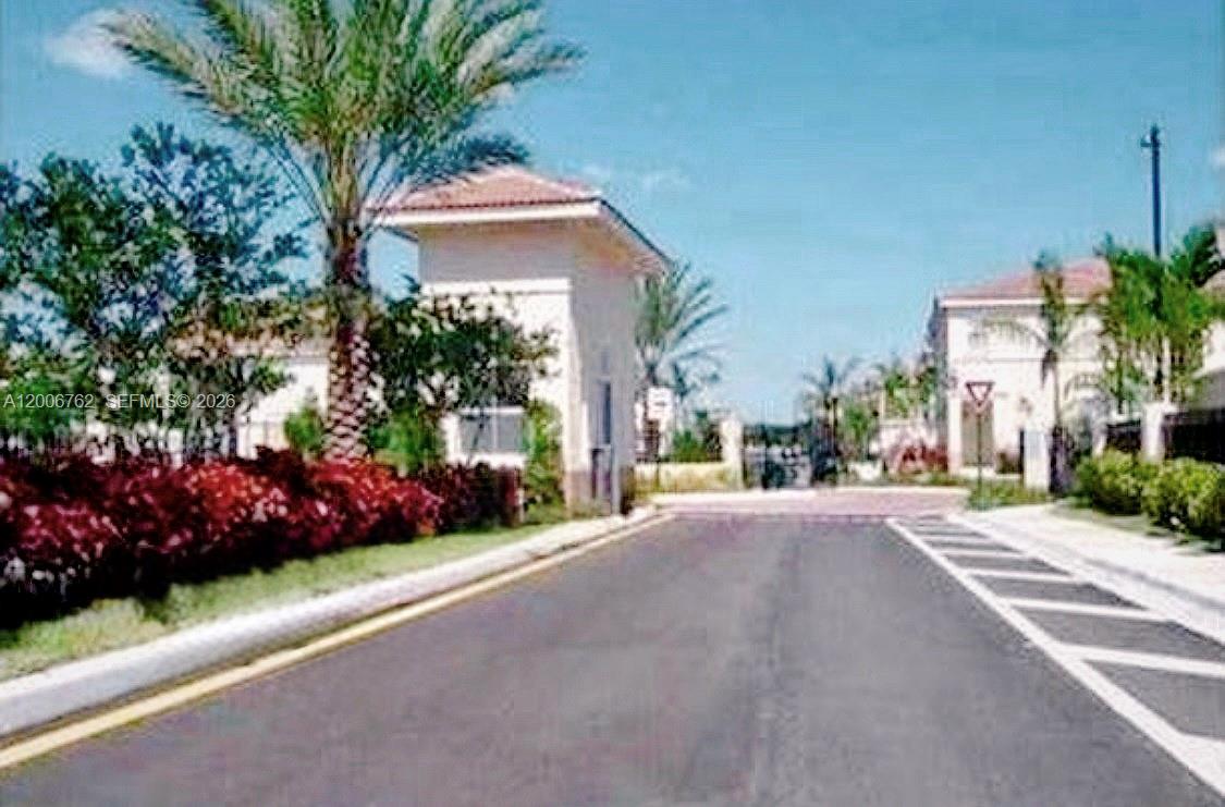 15810 Southwest 40th Street, Unit 57 Miramar, FL 33027 - Photo 1 of 20 a front view of a house with a garden and plants