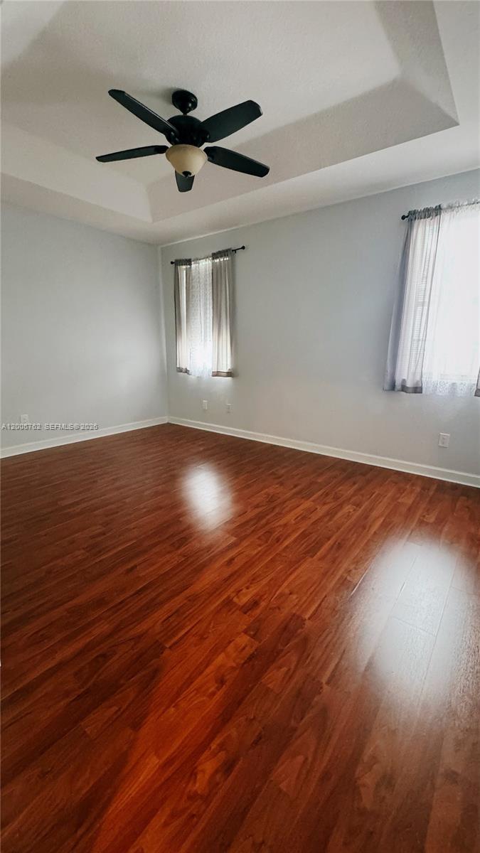 15810 Southwest 40th Street, Unit 57 Miramar, FL 33027 - Photo 15 of 20 a view of an empty room with wooden floor and a window