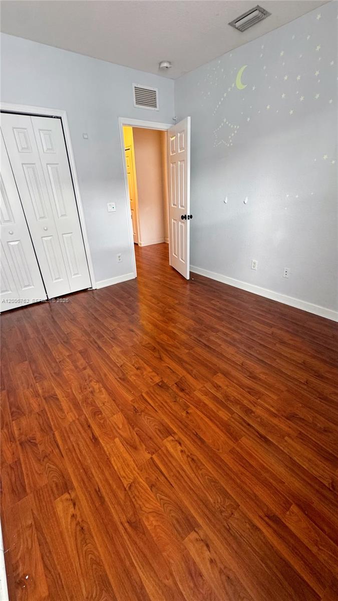 15810 Southwest 40th Street, Unit 57 Miramar, FL 33027 - Photo 16 of 20 a view of empty room with wooden floor