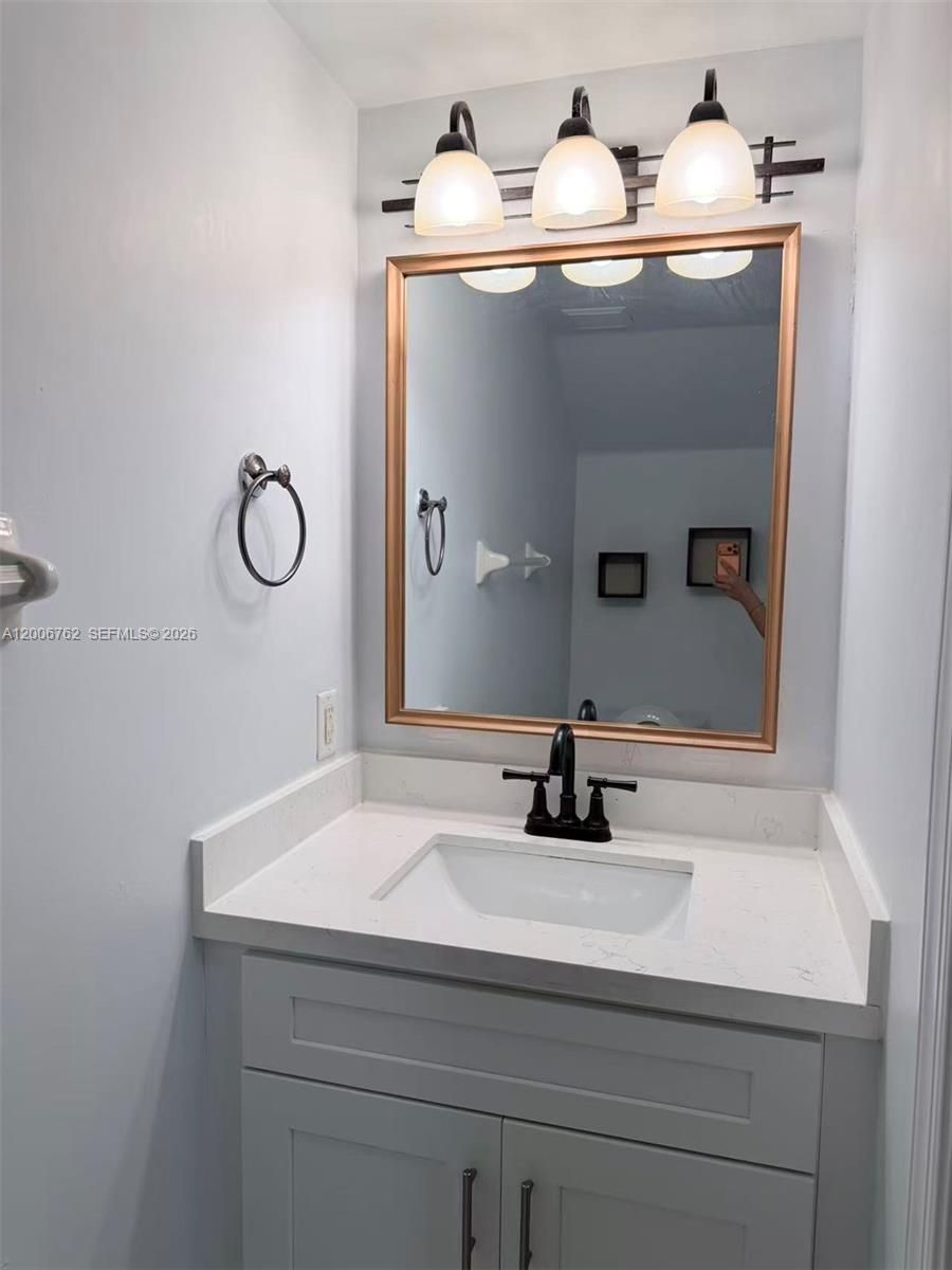 15810 Southwest 40th Street, Unit 57 Miramar, FL 33027 - Photo 19 of 20 a bathroom with a sink and a mirror