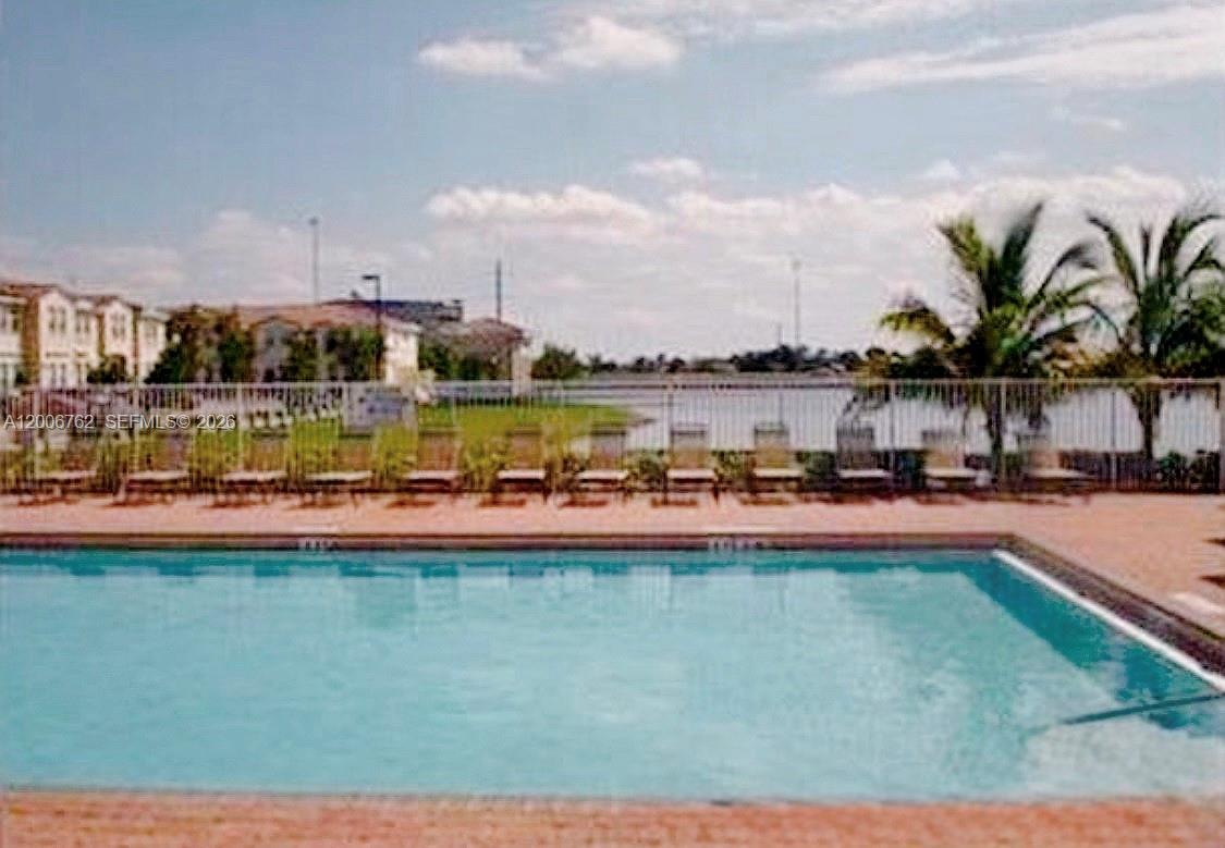 15810 Southwest 40th Street, Unit 57 Miramar, FL 33027 - Photo 3 of 20 a view of a swimming pool with outdoor seating