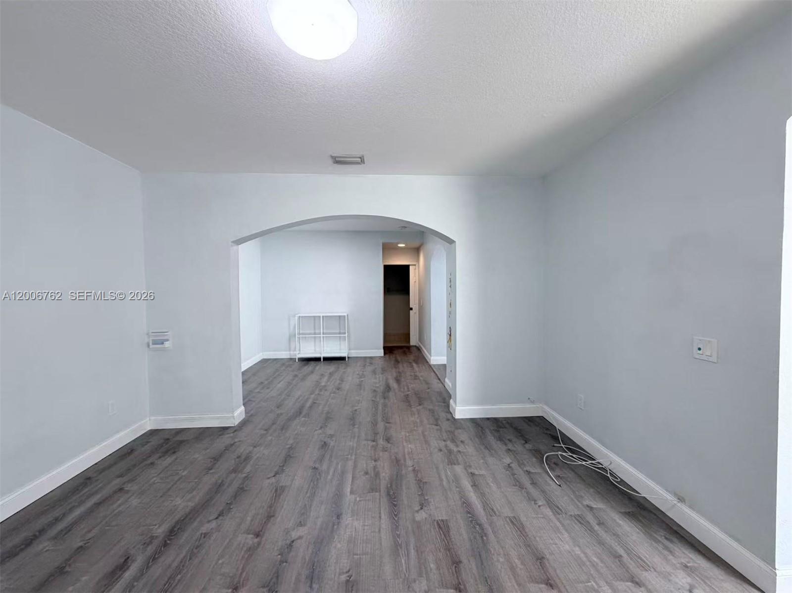 15810 Southwest 40th Street, Unit 57 Miramar, FL 33027 - Photo 4 of 20 a view of a room with wooden floor and window