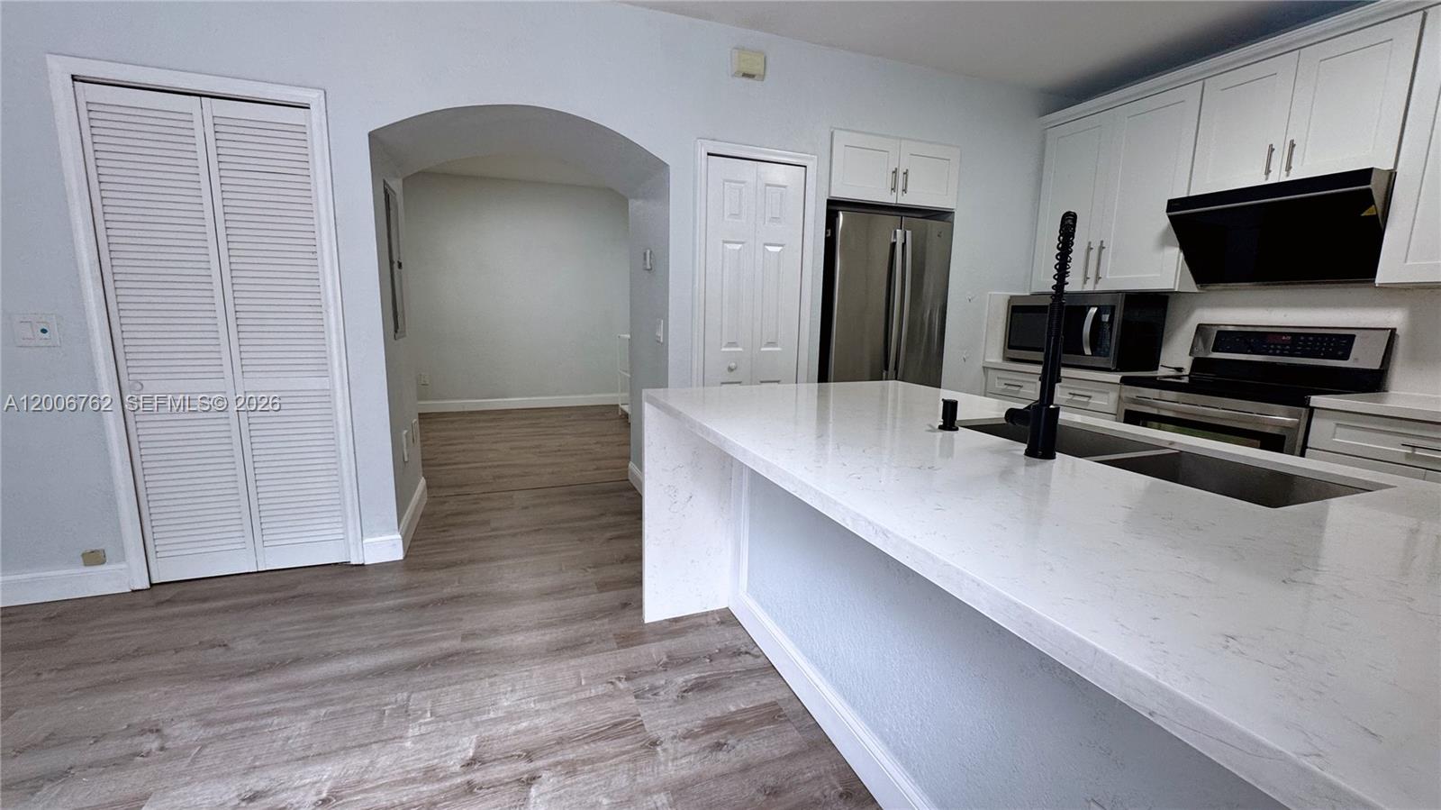 15810 Southwest 40th Street, Unit 57 Miramar, FL 33027 - Photo 8 of 20 a hallway with a computer on a desk and chair