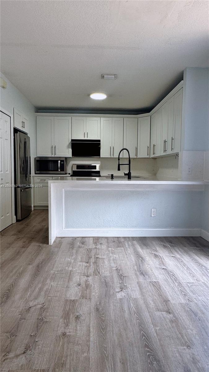 15810 Southwest 40th Street, Unit 57 Miramar, FL 33027 - Photo 9 of 20 a kitchen with stainless steel appliances a refrigerator sink and microwave