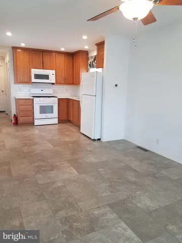 a kitchen with stainless steel appliances a refrigerator and a stove top oven