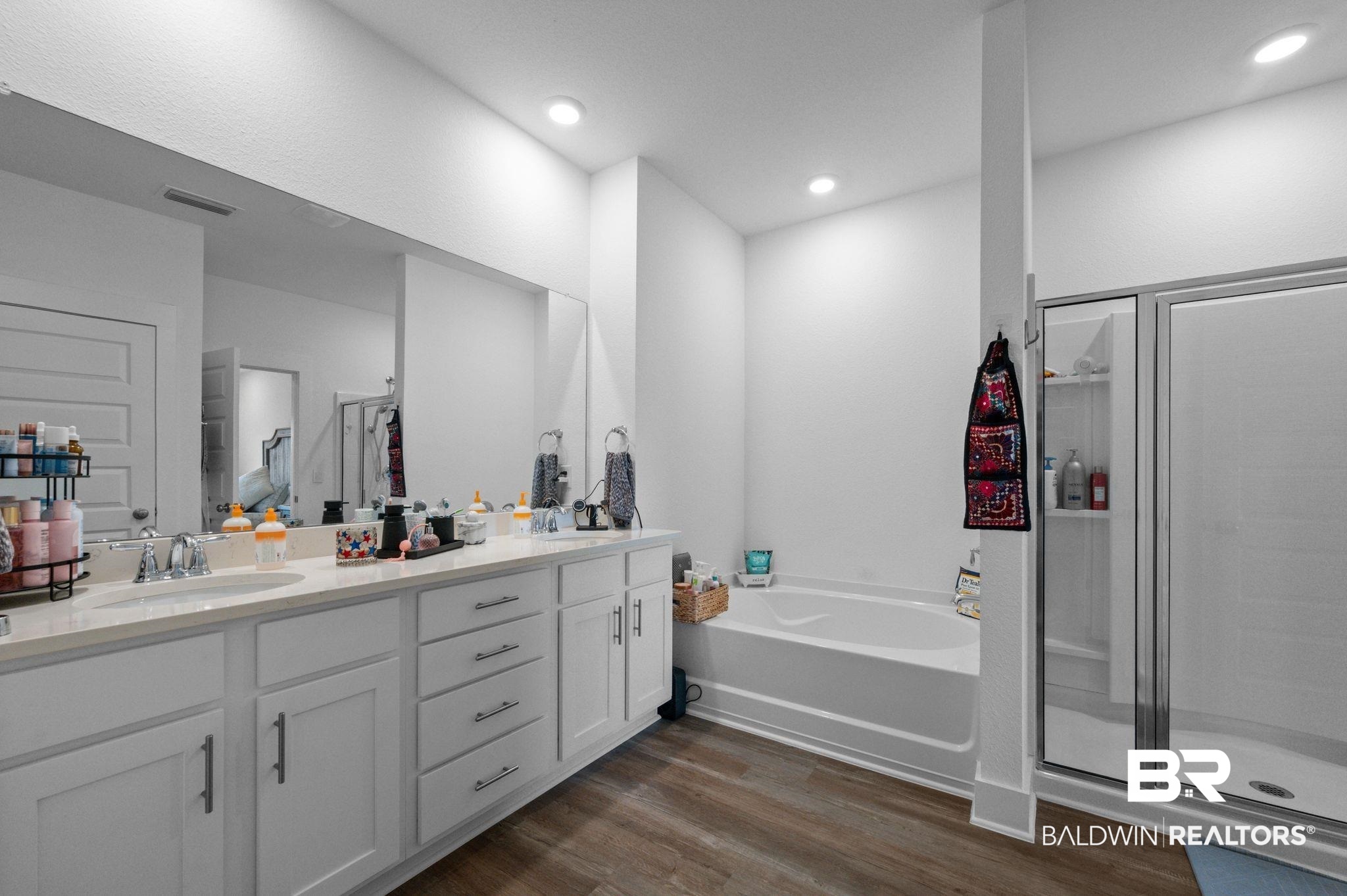 8508 Rosedown Lane Daphne, AL 36526 - Photo 21 of 29 Bathroom with a stall shower, double vanity, dark wood-type flooring, a garden tub, and recessed lighting