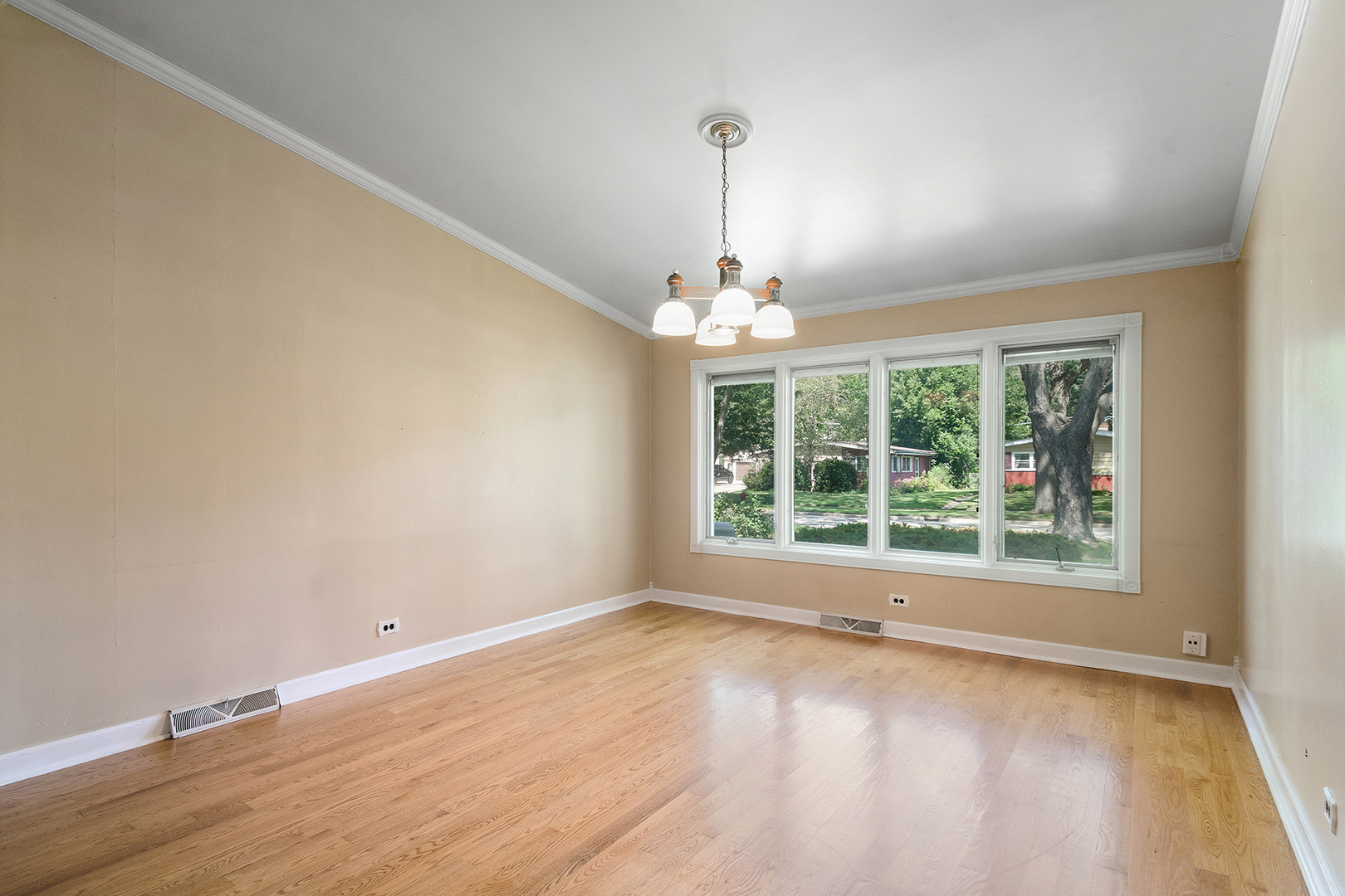 2305 Fulle Street Rolling Meadows, IL 60008 - Photo 6 of 15 a view of an empty room with wooden floor and a window