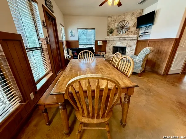 a view of a livingroom with furniture window and hardwood floor