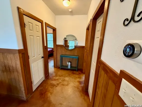 a view of a hallway to rooms and stairs