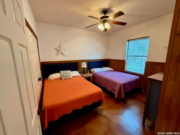 a bedroom with two beds and a chandelier