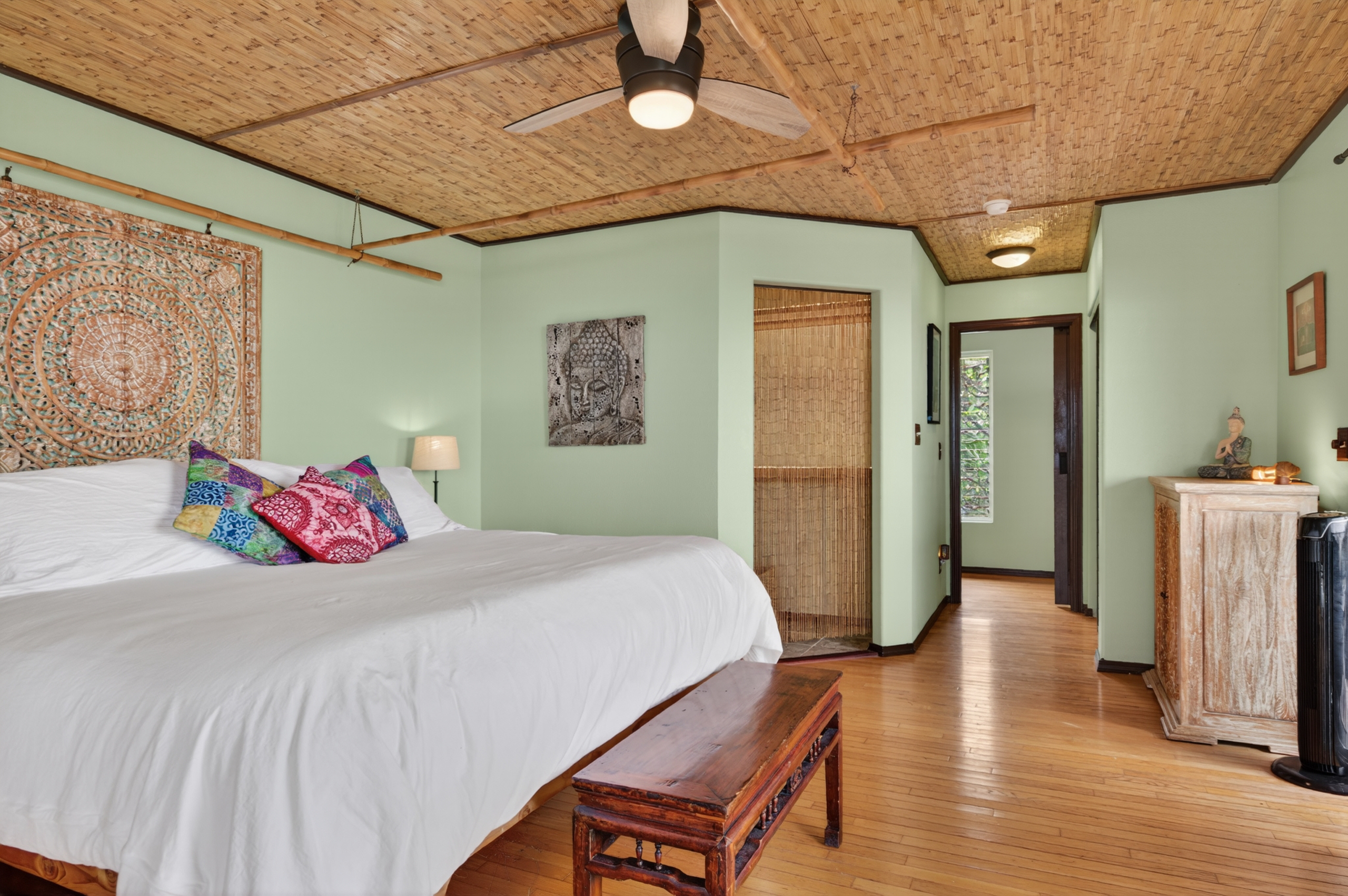 87-299 Kaohe Road Captain Cook, HI 96704 - Photo 12 of 30 a bedroom with a large bed and a chandelier