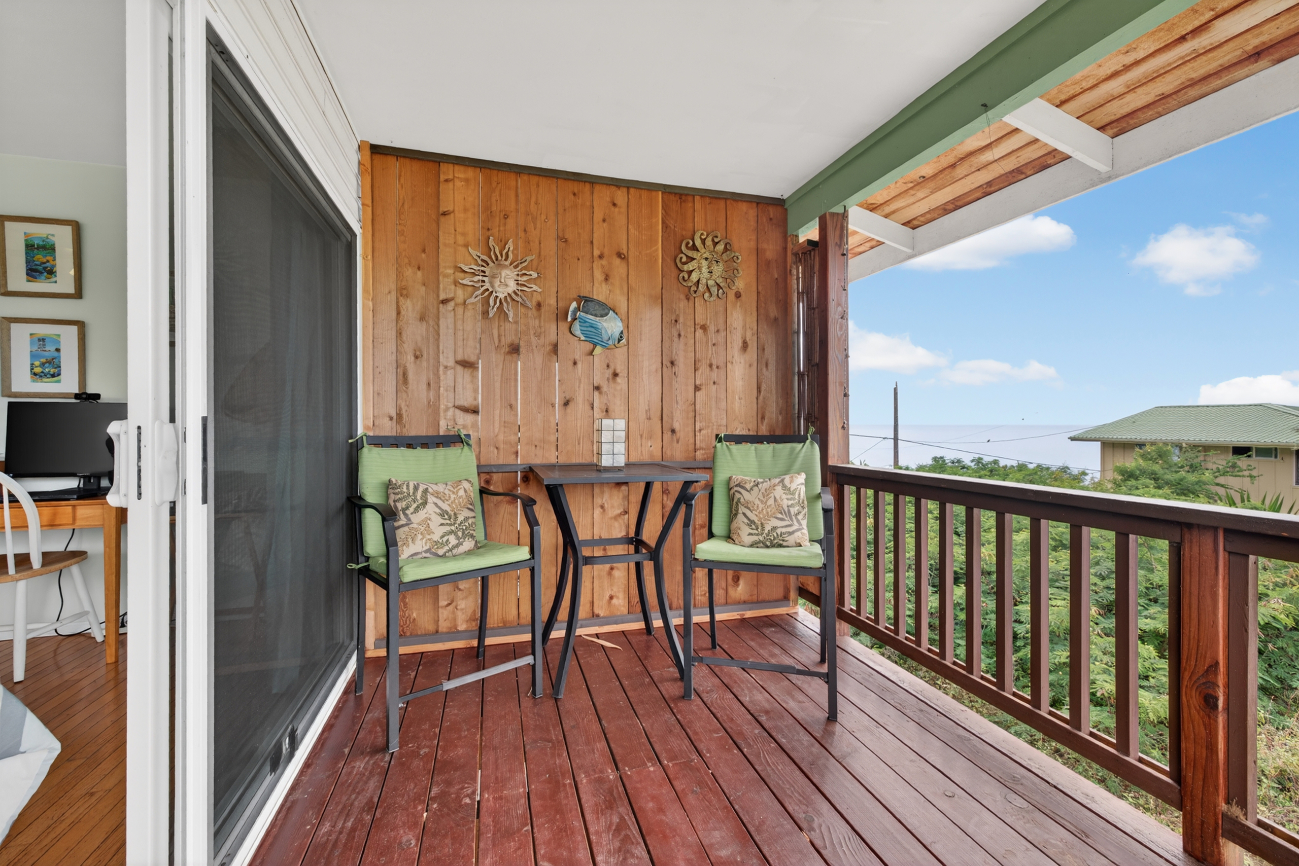 87-299 Kaohe Road Captain Cook, HI 96704 - Photo 20 of 30 a view of a balcony with chairs and wooden floor